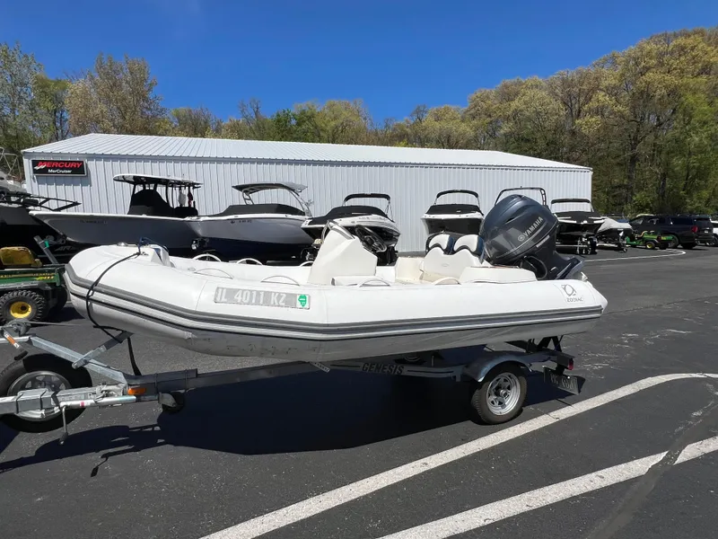 Slide: The Image of 2019 Zodiac Yachtline 400 inflatable boat on trailer in parking lot. - 1