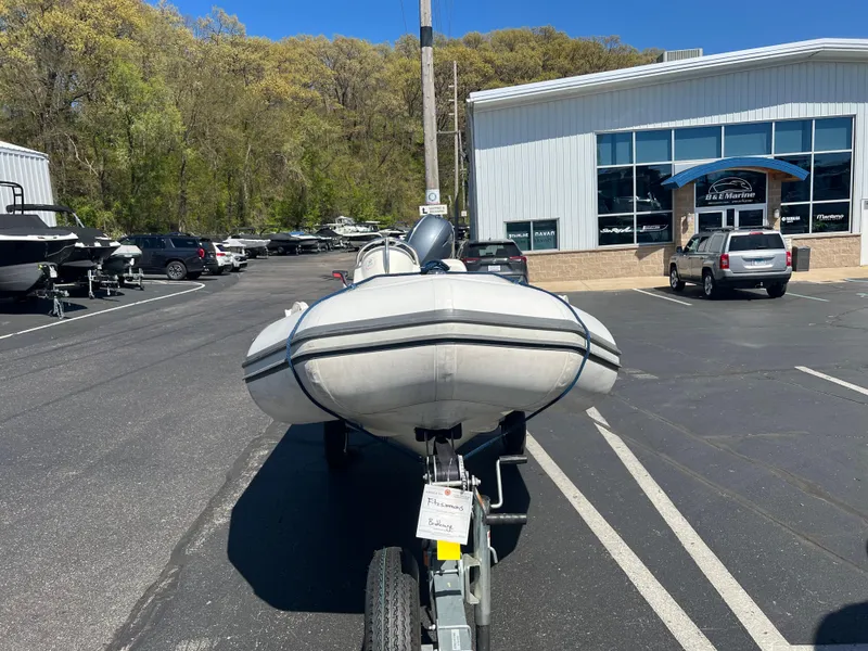 Slide: The Image of 2019 Zodiac Yachtline 400 inflatable boat on trailer in parking lot near dealership. - 2
