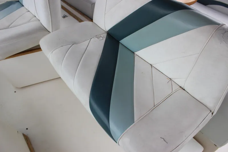Slide: The Image of 1988 Sea Ray 340 Sundancer boat seat with blue and white upholstery design. - 11