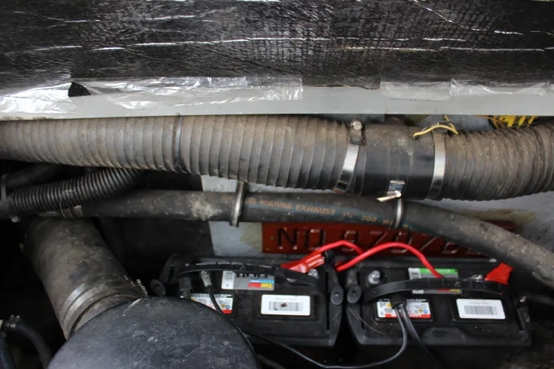 Slide: The Image of Engine compartment of 1988 Sea Ray 340 Sundancer with visible batteries and hoses. - 12