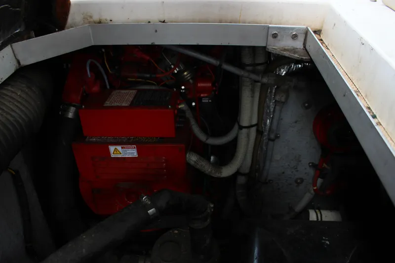 Slide: The Image of Engine compartment of a 1988 Sea Ray 340 Sundancer boat, featuring red engine components. - 13