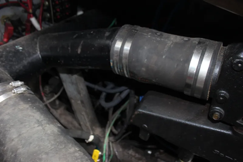 Slide: The Image of Engine compartment of 1988 Sea Ray 340 Sundancer, showing hoses and mechanical components. - 14