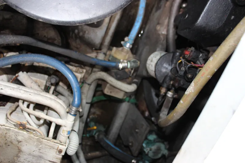 Slide: The Image of Engine compartment of 1988 Sea Ray 340 Sundancer with visible hoses and components. - 15