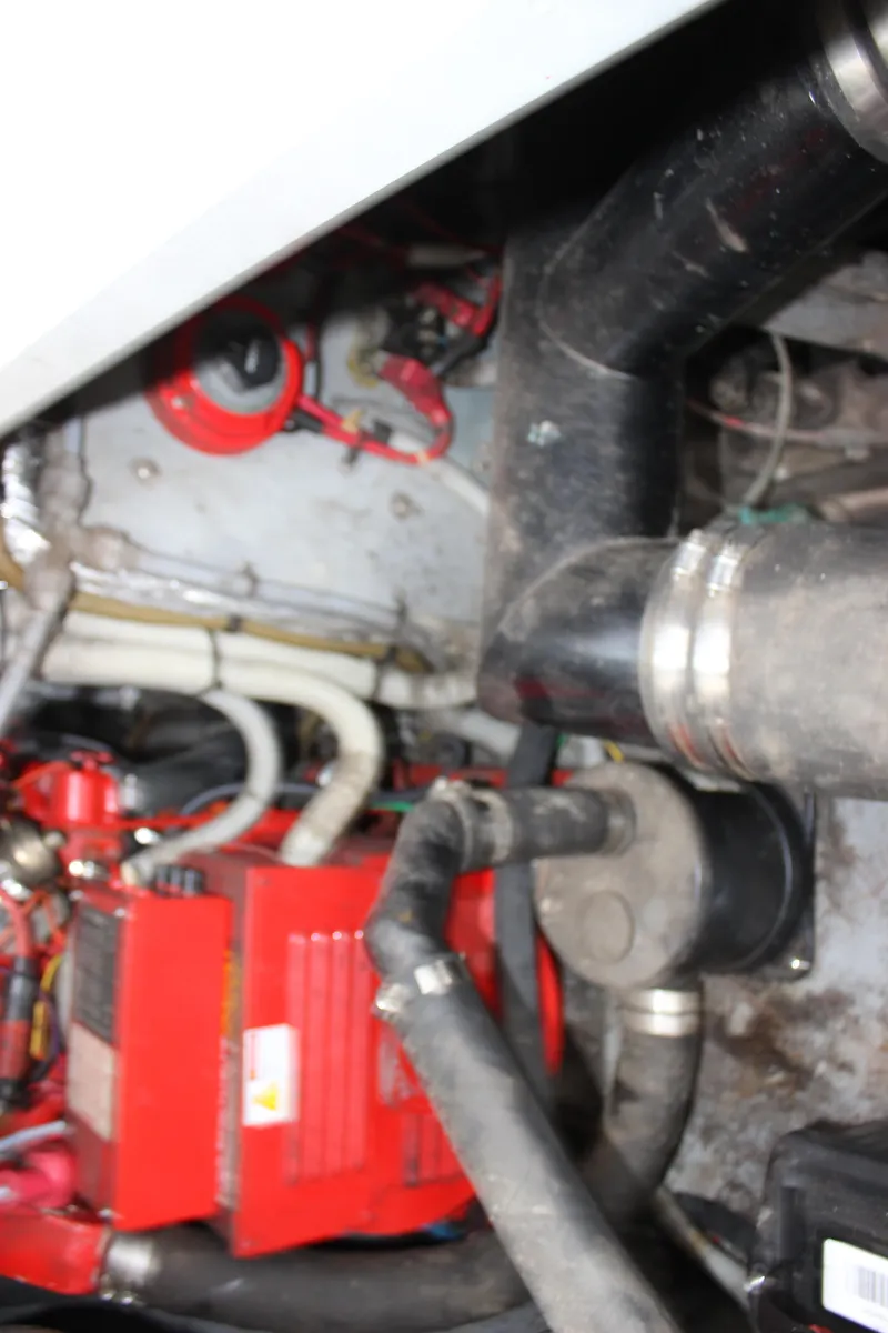 Slide: The Image of Engine compartment of a 1988 Sea Ray 340 Sundancer with visible hoses and components. - 16
