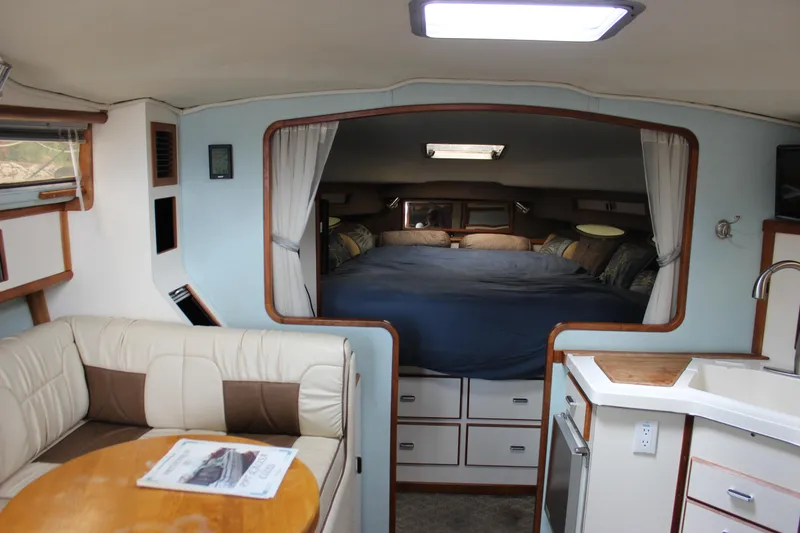 Slide: The Image of Interior of 1988 Sea Ray 340 Sundancer with cozy cabin and seating area. - 17