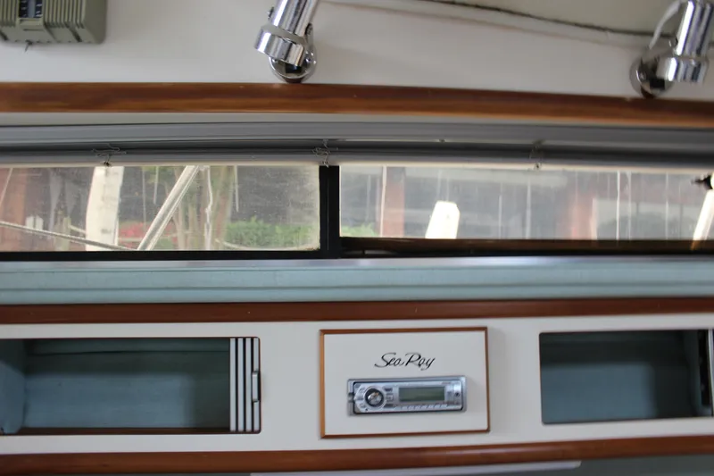 Slide: The Image of 1988 Sea Ray 340 Sundancer interior with wood trim and stereo system. - 25