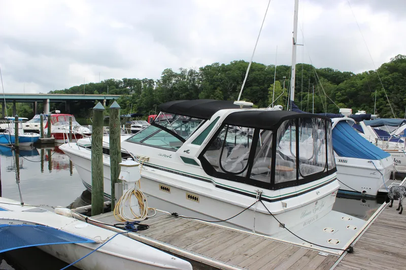 Slide: The Image of 1988 Sea Ray 340 Sundancer docked at a marina with other boats. - 3