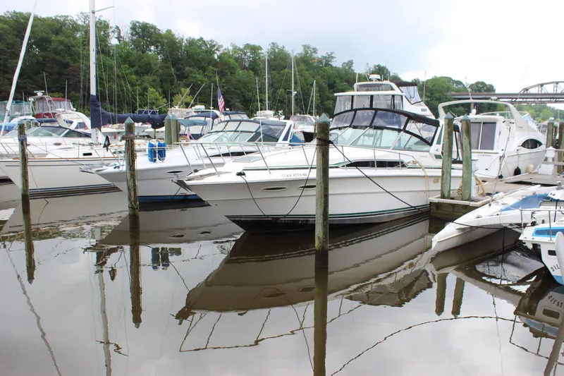 Slide: The Image of 1988 Sea Ray 340 Sundancer docked in a marina, surrounded by other boats. - 36