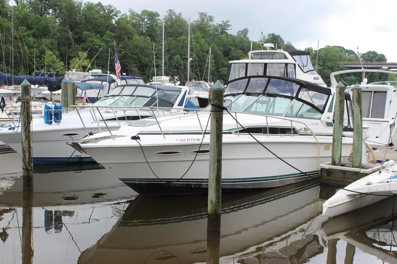 Slide: The Image of 1988 Sea Ray 340 Sundancer docked at a marina with other boats. - 37