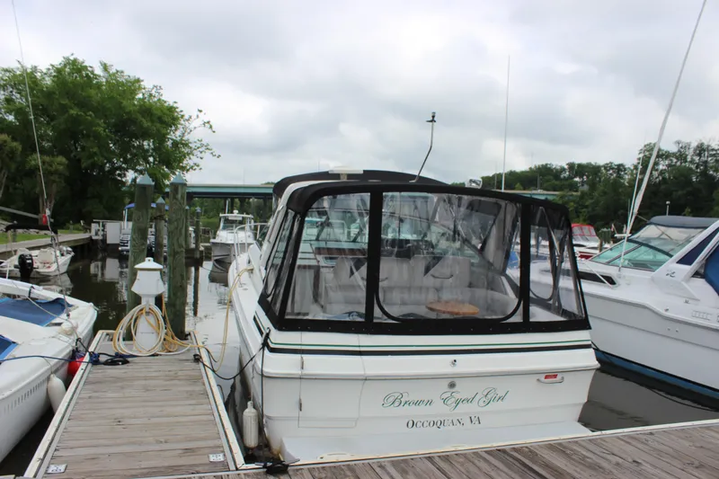 Slide: The Image of 1988 Sea Ray 340 Sundancer docked at marina, rear view with canopy. - 4
