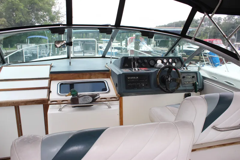 Slide: The Image of 1988 Sea Ray 340 Sundancer cockpit with steering wheel and control panel. - 6