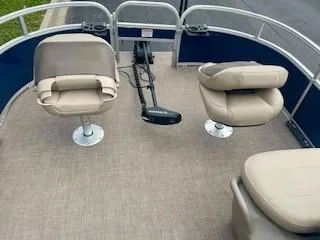 Slide: The Image of 2023 Sun Tracker Bass Buggy 16 XL interior with beige seating and steering console. - 5