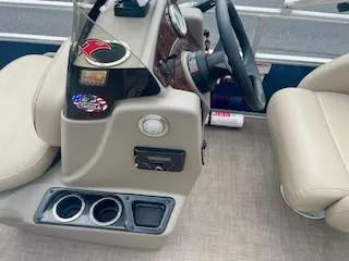 Slide: The Image of 2023 Sun Tracker Bass Buggy 16 XL boat console with steering wheel and cup holders. - 9