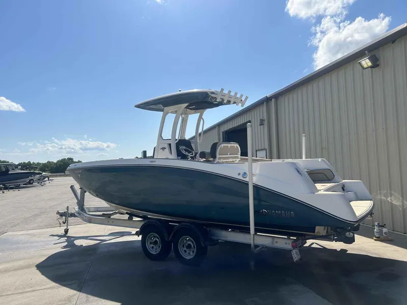 Slide: The Image of 2021 Yamaha Boats 255 FSH Sport E on trailer, parked outdoors near a building. - 3