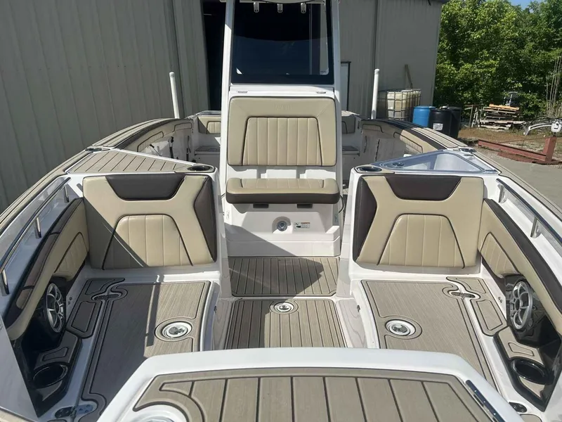 Slide: The Image of 2021 Yamaha Boats 255 FSH Sport E interior with beige seating and sleek design. - 4