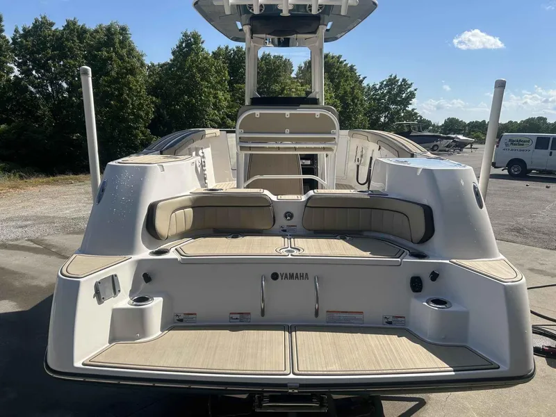 Slide: The Image of 2021 Yamaha Boats 255 FSH Sport E, rear view, docked outdoors. - 5