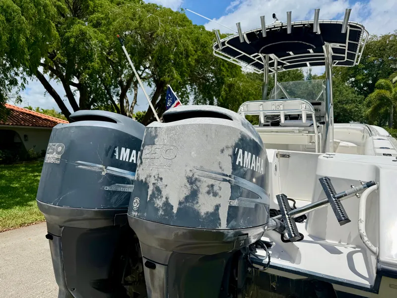 Slide: The Image of 2006 Edgewater 265CC boat with twin Yamaha outboard motors, parked outdoors. - 14