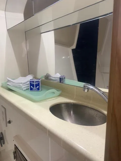 Slide: The Image of Stolper 38 yacht bathroom with sink, mirror, and toiletries, 2004 model. - 12