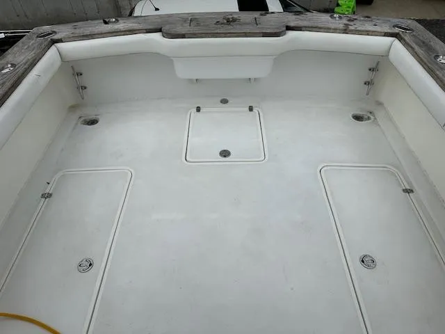 Slide: The Image of Spacious deck of a 2004 Stolper 38 boat, featuring storage compartments and clean design. - 23