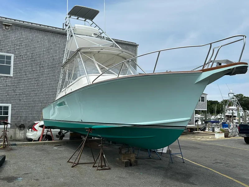 Slide: The Image of 2004 Stolper 38 boat on stands near a building, ready for maintenance. - 3