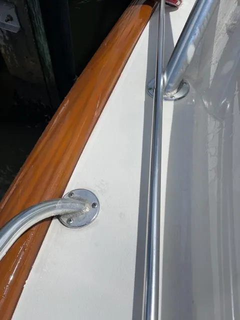 Slide: The Image of Close-up of a 2004 Stolper 38 boat railing and wooden trim. - 6