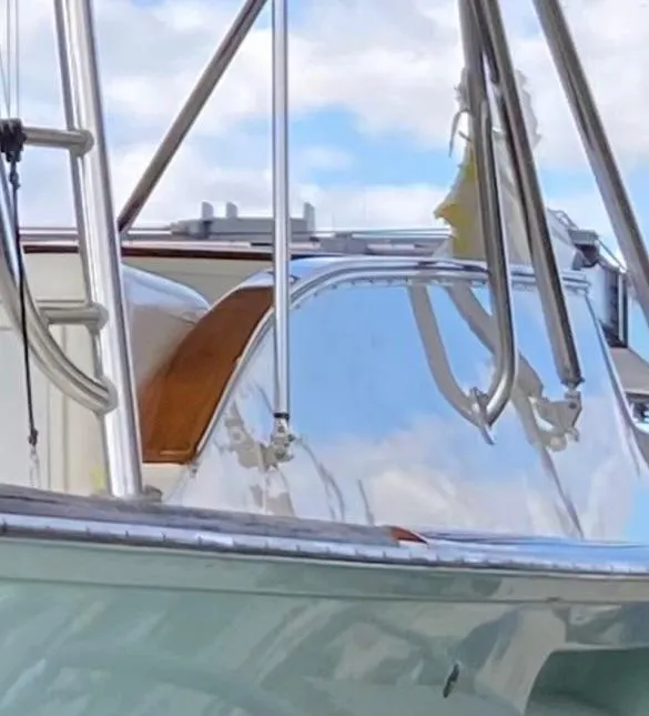 Slide: The Image of Close-up of a 2004 Stolper 38 boat with metal railings and clear sky background. - 7