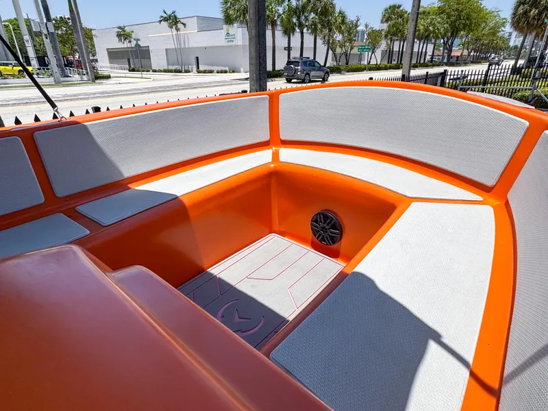 Slide: The Image of 2024 Vision Marine Technologies Phantom boat interior with orange and gray seating. - 2