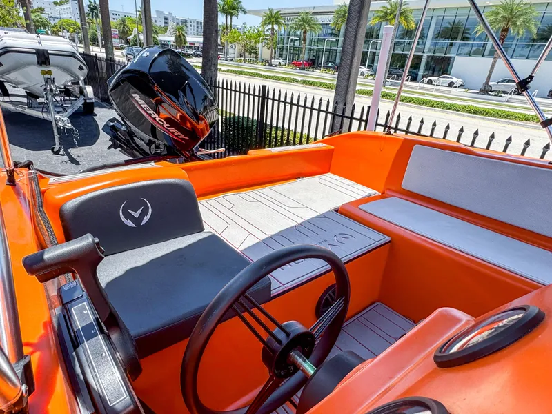 Slide: The Image of 2024 Vision Marine Technologies Phantom boat interior with orange seating and steering wheel. - 3