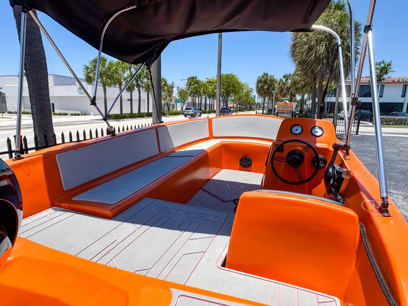 Slide: The Image of 2024 Vision Marine Technologies Phantom boat with vibrant orange interior and modern design. - 6