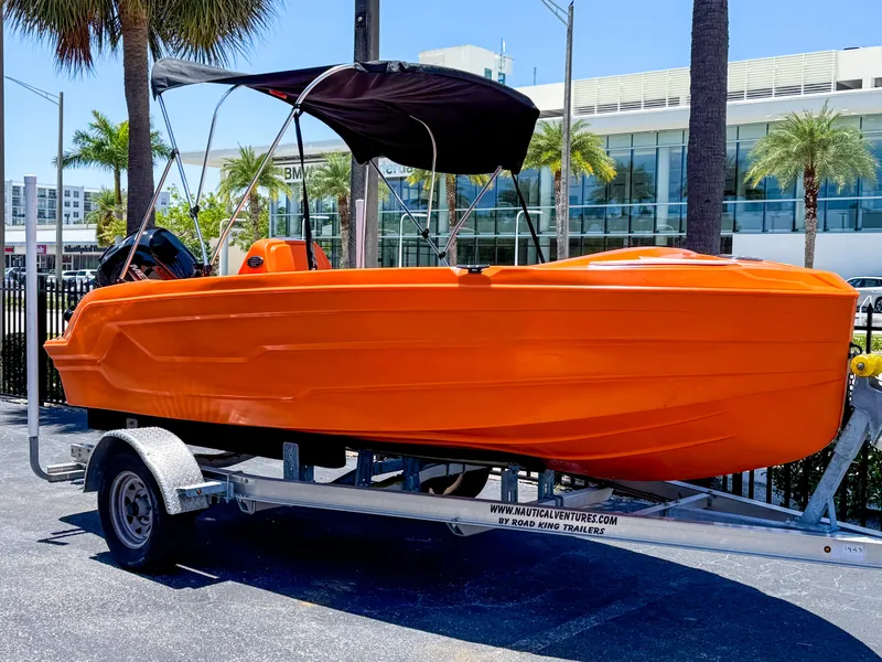 Slide: The Image of 2024 Vision Marine Technologies Phantom boat in vibrant orange on a trailer. - 7