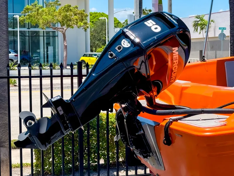 Slide: The Image of 2024 Vision Marine Technologies Phantom with Mercury outboard motor, displayed outdoors. - 8