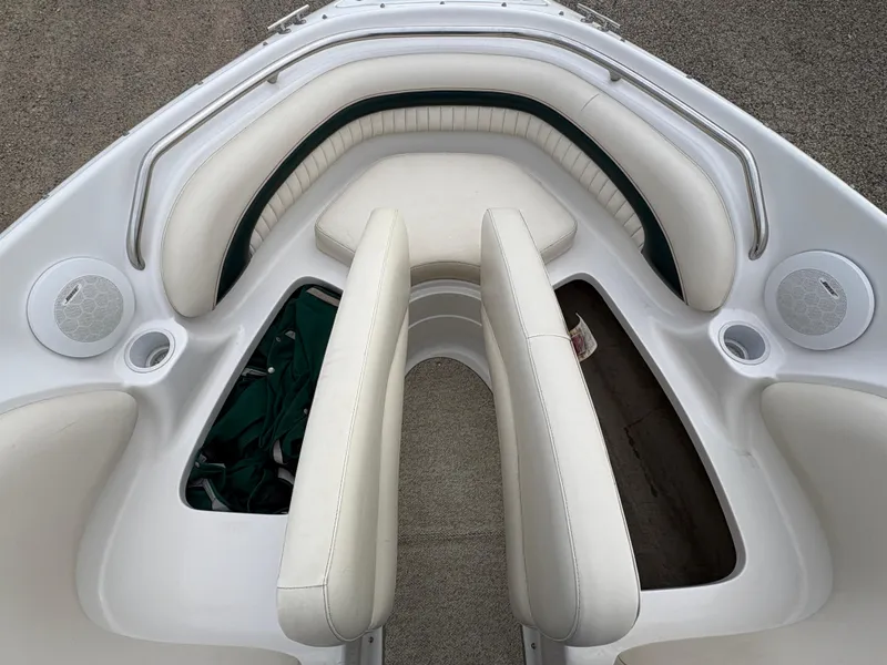 Slide: The Image of 1999 Chris-Craft 210 Bowrider interior with white seating and storage compartments. - 11