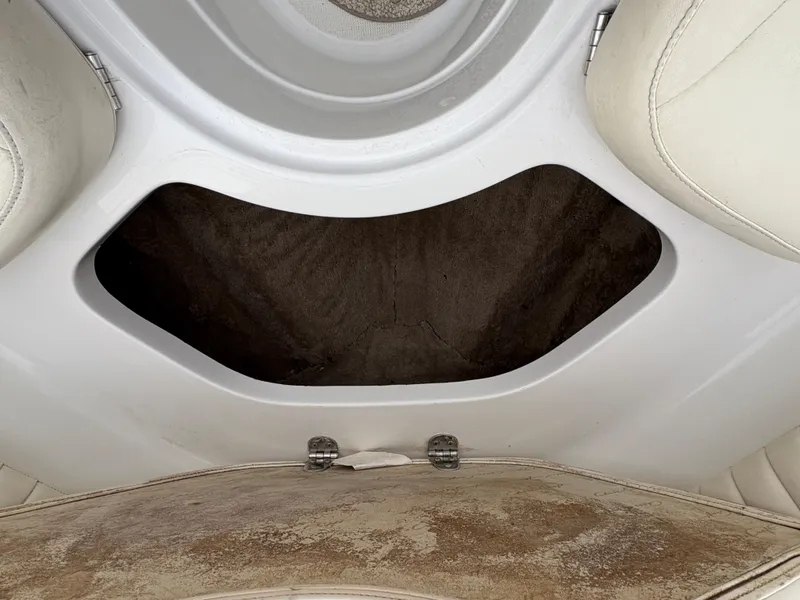 Slide: The Image of 1999 Chris-Craft 210 Bowrider interior storage compartment with beige upholstery. - 12