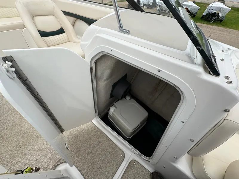 Slide: The Image of 1999 Chris-Craft 210 Bowrider interior storage compartment with portable toilet. - 17