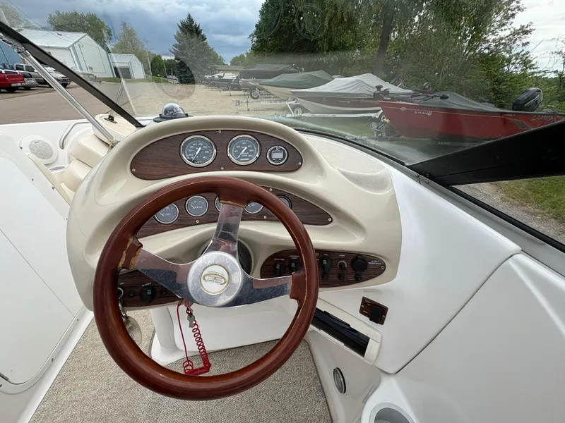 Slide: The Image of 1999 Chris-Craft 210 Bowrider dashboard with wooden steering wheel and instrument panel. - 20