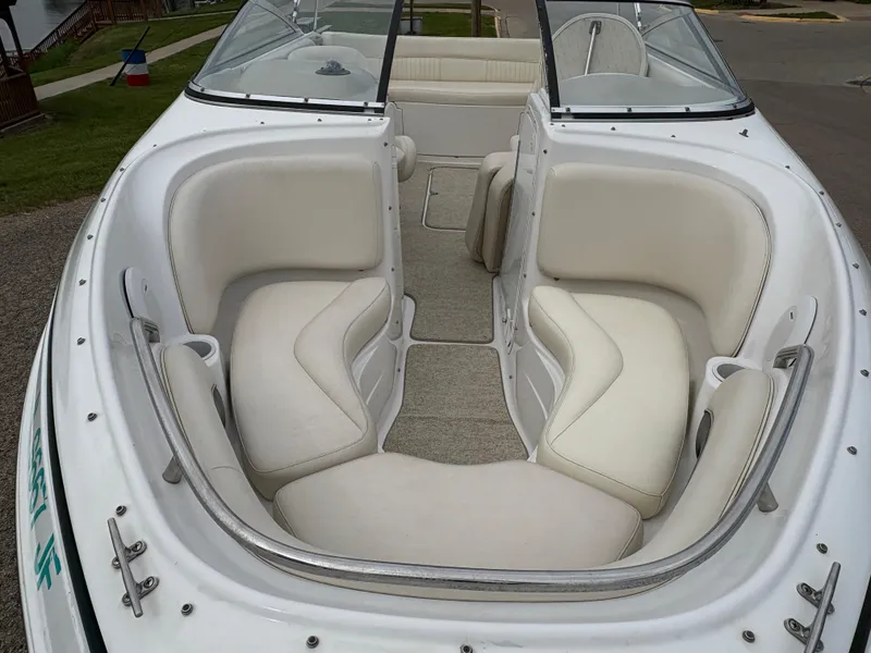 Slide: The Image of 1999 Chris-Craft 210 Bowrider with white seating and open bow design. - 8