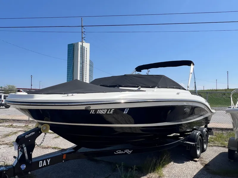 Slide: The Image of 2017 Sea Ray SPX 210 boat on trailer, parked outdoors under clear sky. - 1