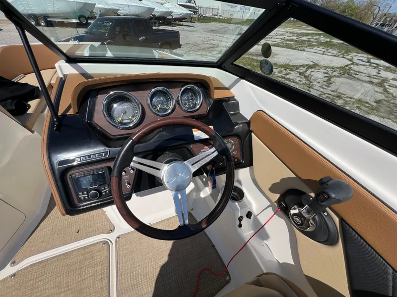 Slide: The Image of 2017 Sea Ray SPX 210 boat dashboard with steering wheel and gauges. - 10
