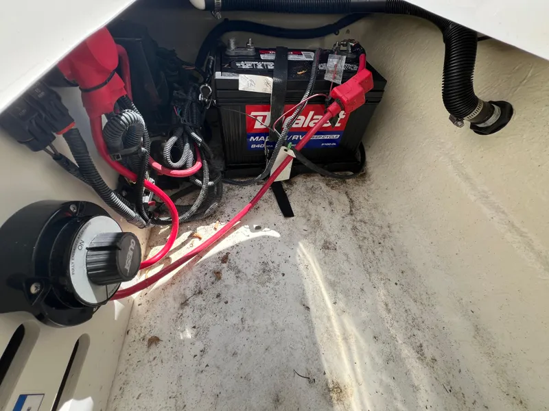 Slide: The Image of Battery compartment of a 2017 Sea Ray SPX 210 boat with wiring and connections. - 12