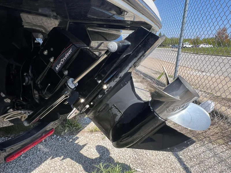 Slide: The Image of 2017 Sea Ray SPX 210 boat with MerCruiser outdrive, parked near a chain-link fence. - 4