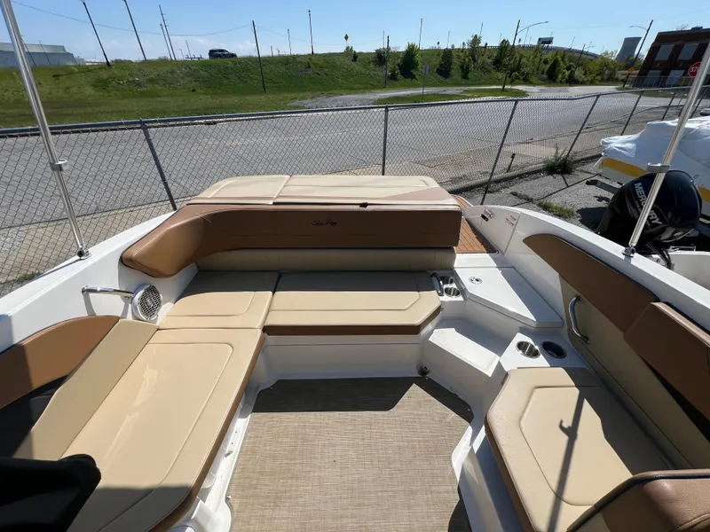 Slide: The Image of 2017 Sea Ray SPX 210 boat interior with tan seating and open deck layout. - 8