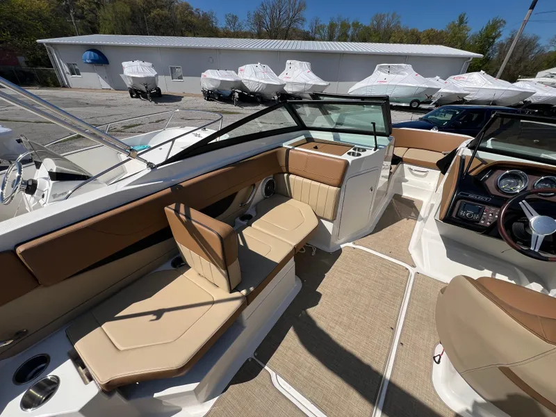 Slide: The Image of 2017 Sea Ray SPX 210 boat interior with tan seating and modern dashboard. - 9