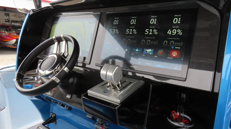 Slide: The Image of 2023 Nor-Tech 390 Sport Center Console dashboard with advanced digital controls and steering wheel. - 10