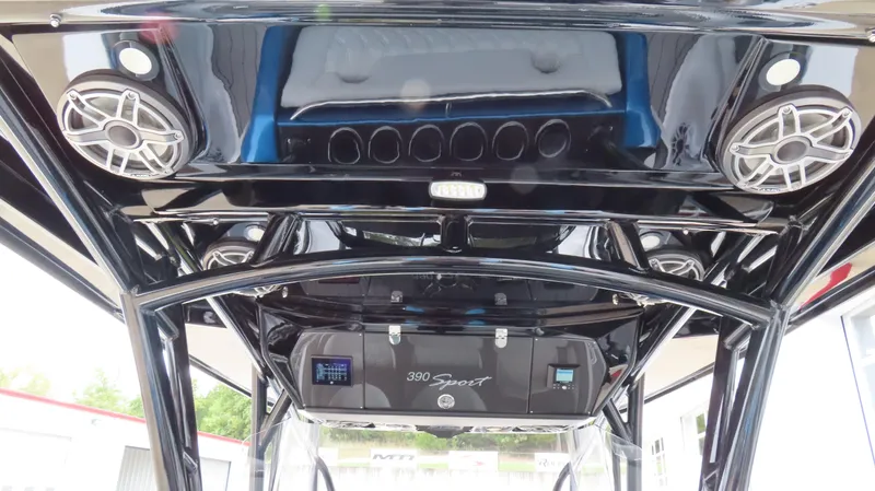 Slide: The Image of 2023 Nor-Tech 390 Sport Center Console boat interior with speakers and sleek design. - 11