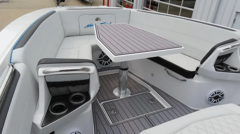 Slide: The Image of 2023 Nor-Tech 390 Sport Center Console interior with seating and table. - 12