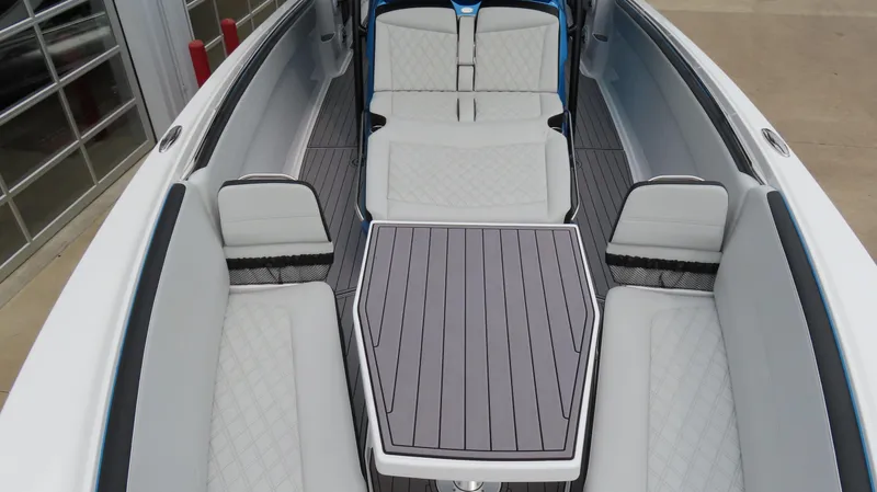 Slide: The Image of 2023 Nor-Tech 390 Sport Center Console interior with sleek seating and modern table design. - 13