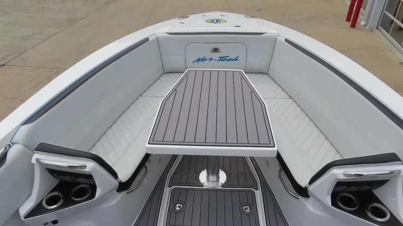 Slide: The Image of 2023 Nor-Tech 390 Sport Center Console with sleek seating and table design. - 14