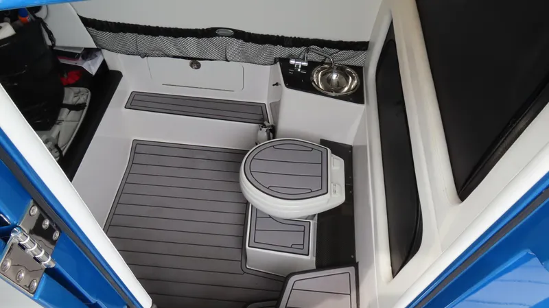 Slide: The Image of 2023 Nor-Tech 390 Sport Center Console interior with toilet and sink. - 18
