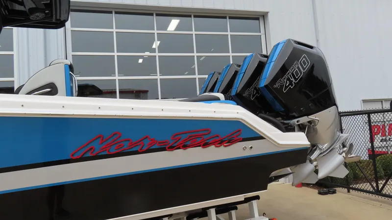 Slide: The Image of 2023 Nor-Tech 390 Sport Center Console with powerful engines, blue and black design. - 2