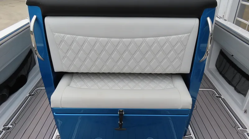 Slide: The Image of 2023 Nor-Tech 390 Sport Center Console seating with diamond-stitched upholstery and blue accents. - 7